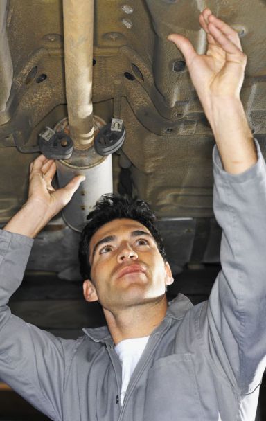 Mechanic is repairing an exhaust pipe in Christchurch 